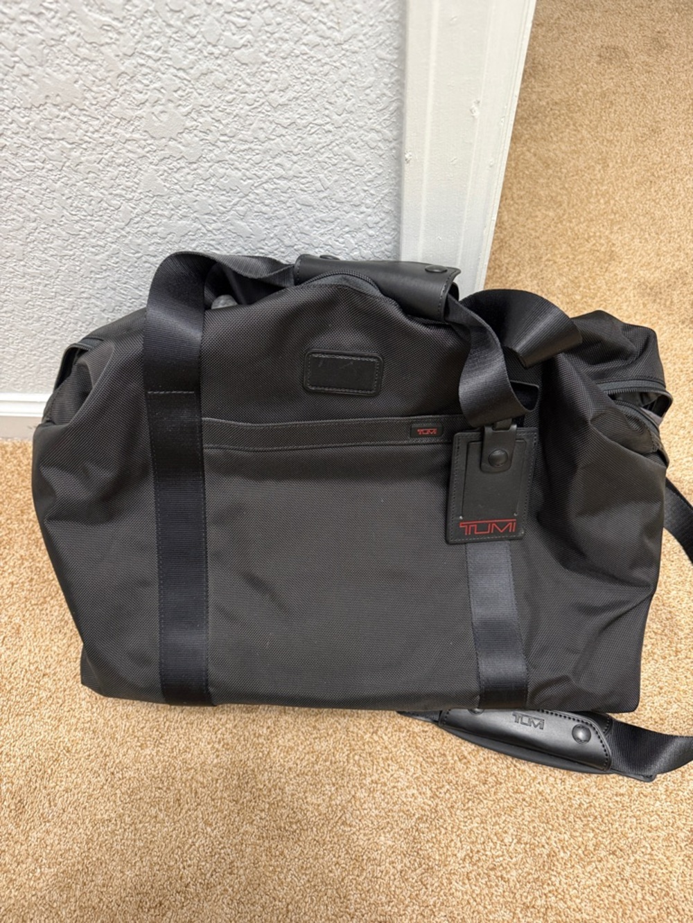 Tumi Black Travel Duffel with Red Logo Accent